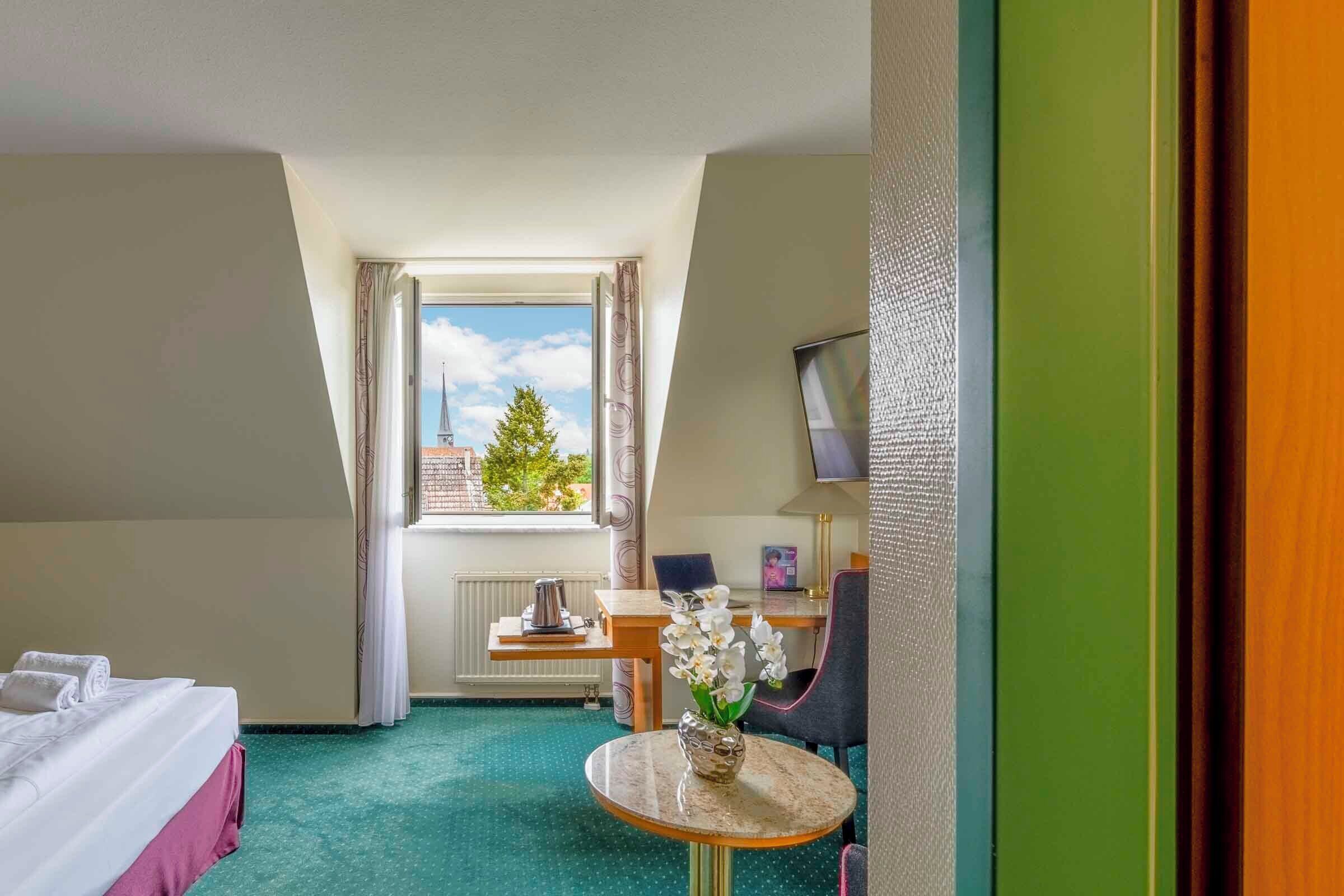 comfort room, 1 single bed, courtyard view | minibar, in-room safe, desk, blackout curtains