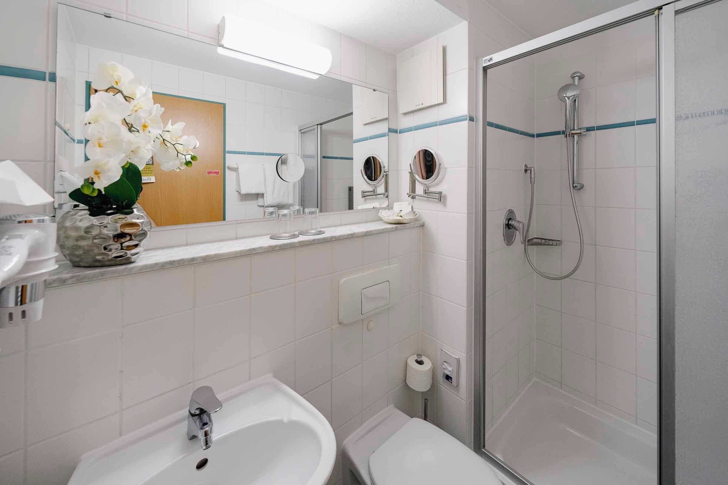 comfort room, 1 queen bed (larger room) | bathroom | shower, free toiletries, hair dryer, slippers