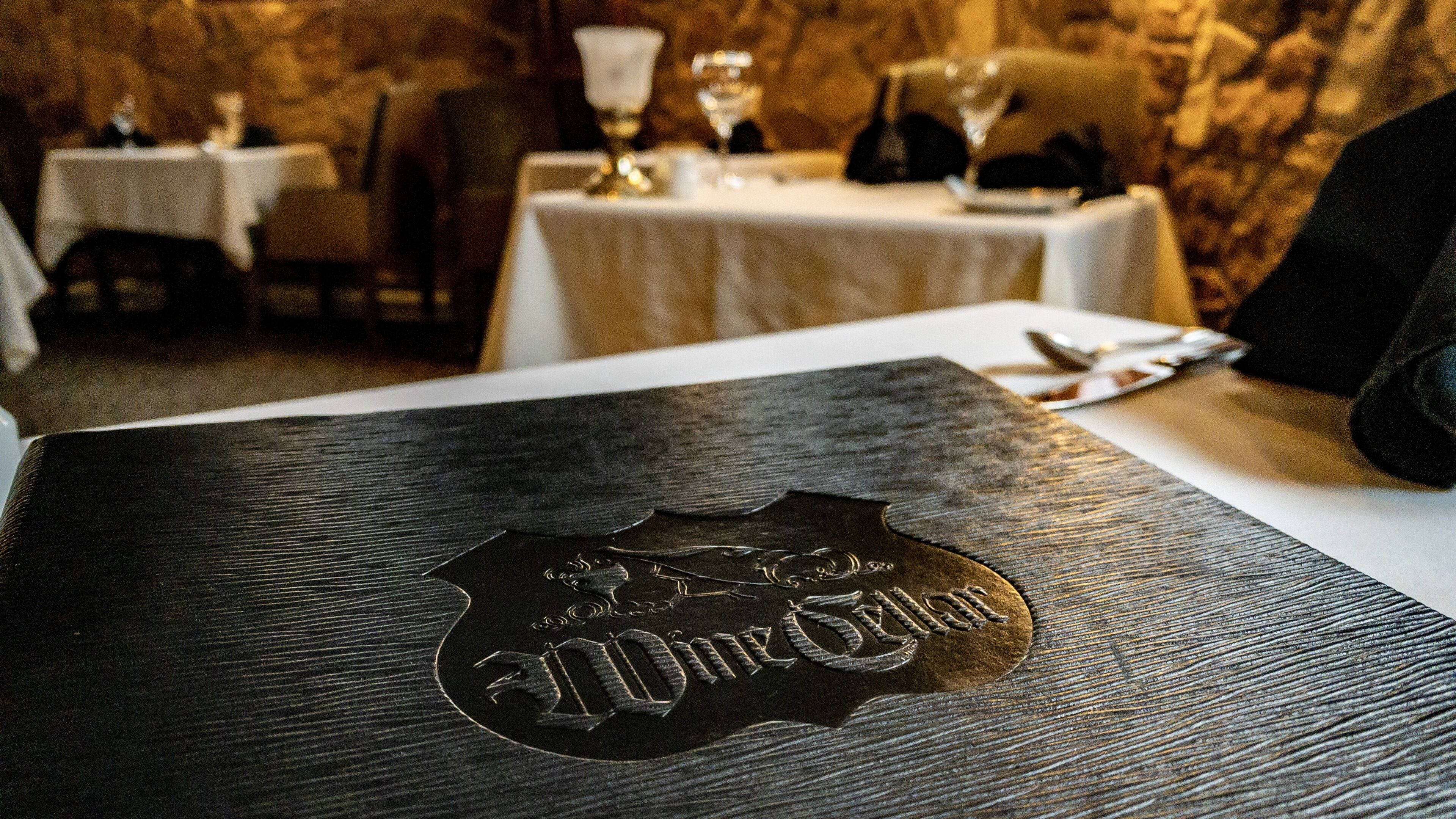 A dining table with a metal plaque reading "The Old Mill".