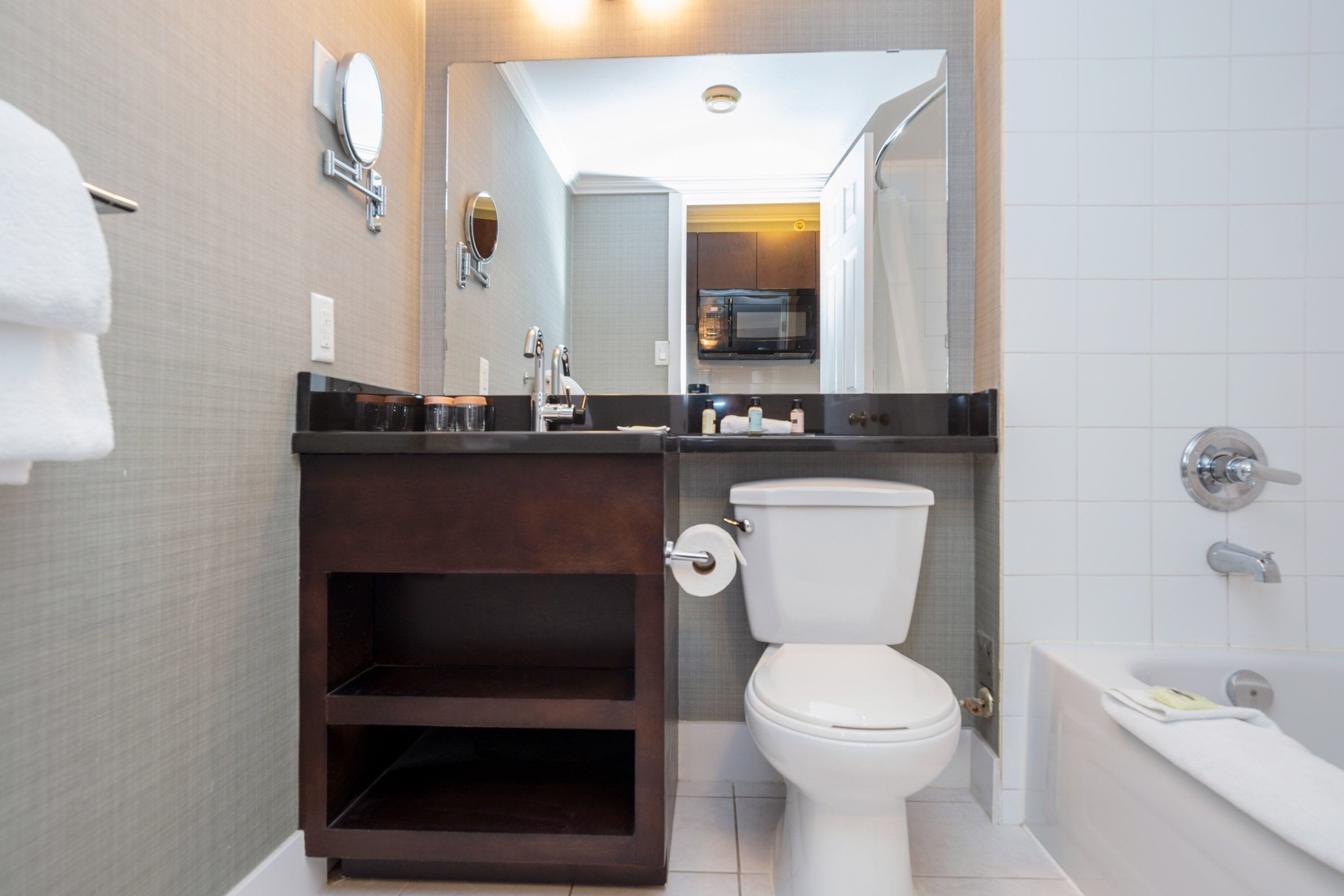 A modern bathroom with a toilet, sink, and bathtub.