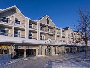 Ein mehrstöckiges Hotel mit einem zentralen Eingang, der mit „Resort Entrance“ gekennzeichnet ist.