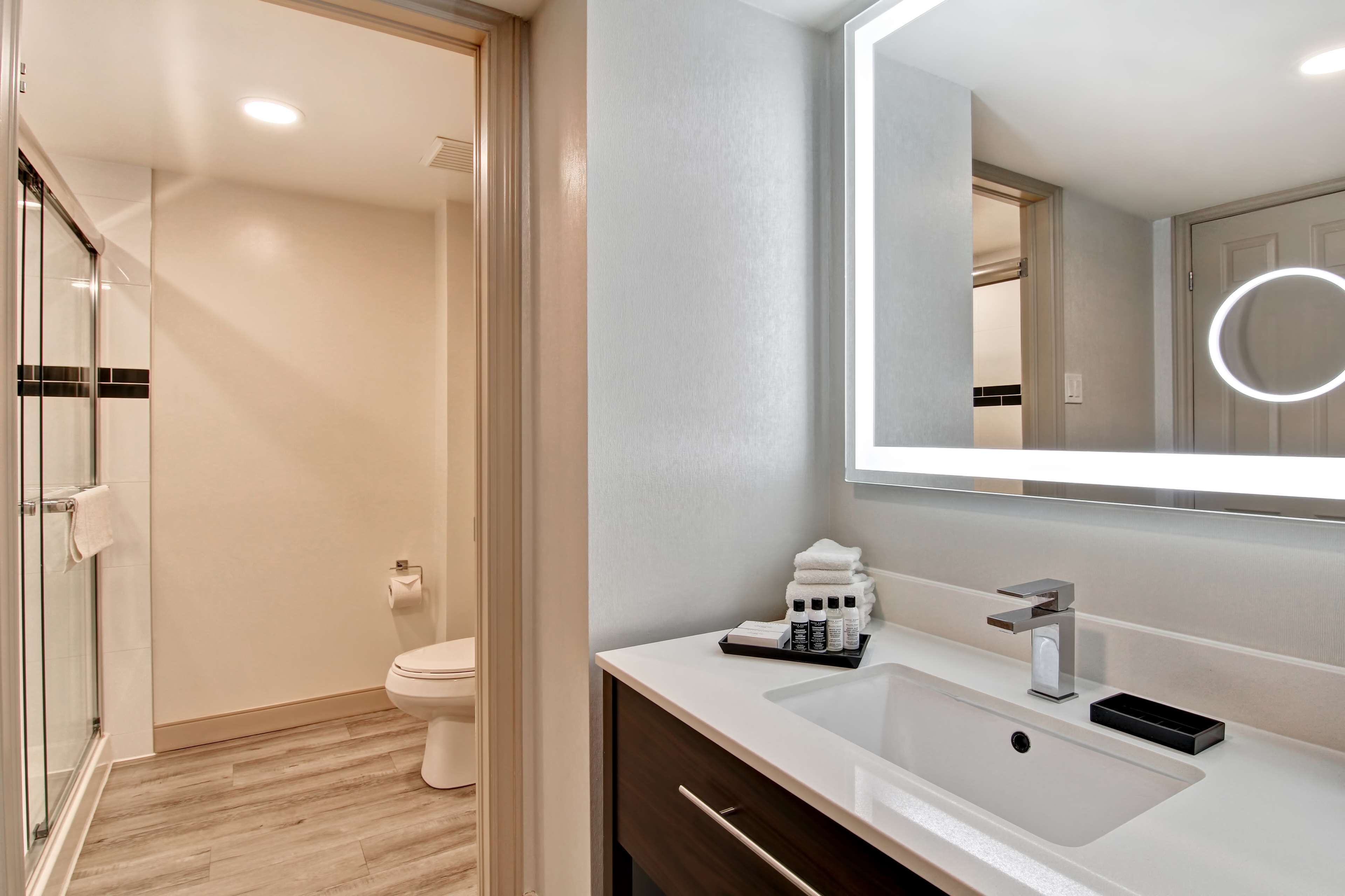 combined shower/bathtub, designer toiletries, hair dryer, towels