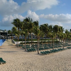 On the beach, white sand, sun loungers, beach towels