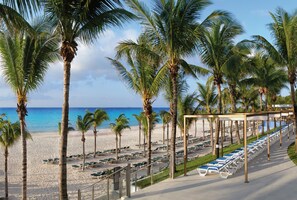 On the beach, white sand, sun-loungers, beach towels