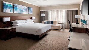 A hotel room with a large bed, a desk, a chair, and a TV. There are two paintings on the wall and a window with curtains. - Delta Hotels by Marriott Basking Ridge (Basking Ridge)