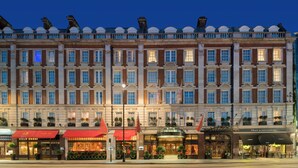 A large, historic hotel with multiple stories, featuring a classic architectural style with symmetrical windows and a central entrance. - The Rubens at the Palace (London)