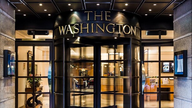 A revolving door entrance to a building with a sign reading 'THE WASHINGTON.' - Washington Mayfair Hotel (London)