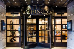 A revolving door entrance to a building with a sign reading 'THE WASHINGTON.' - Washington Mayfair Hotel (London)