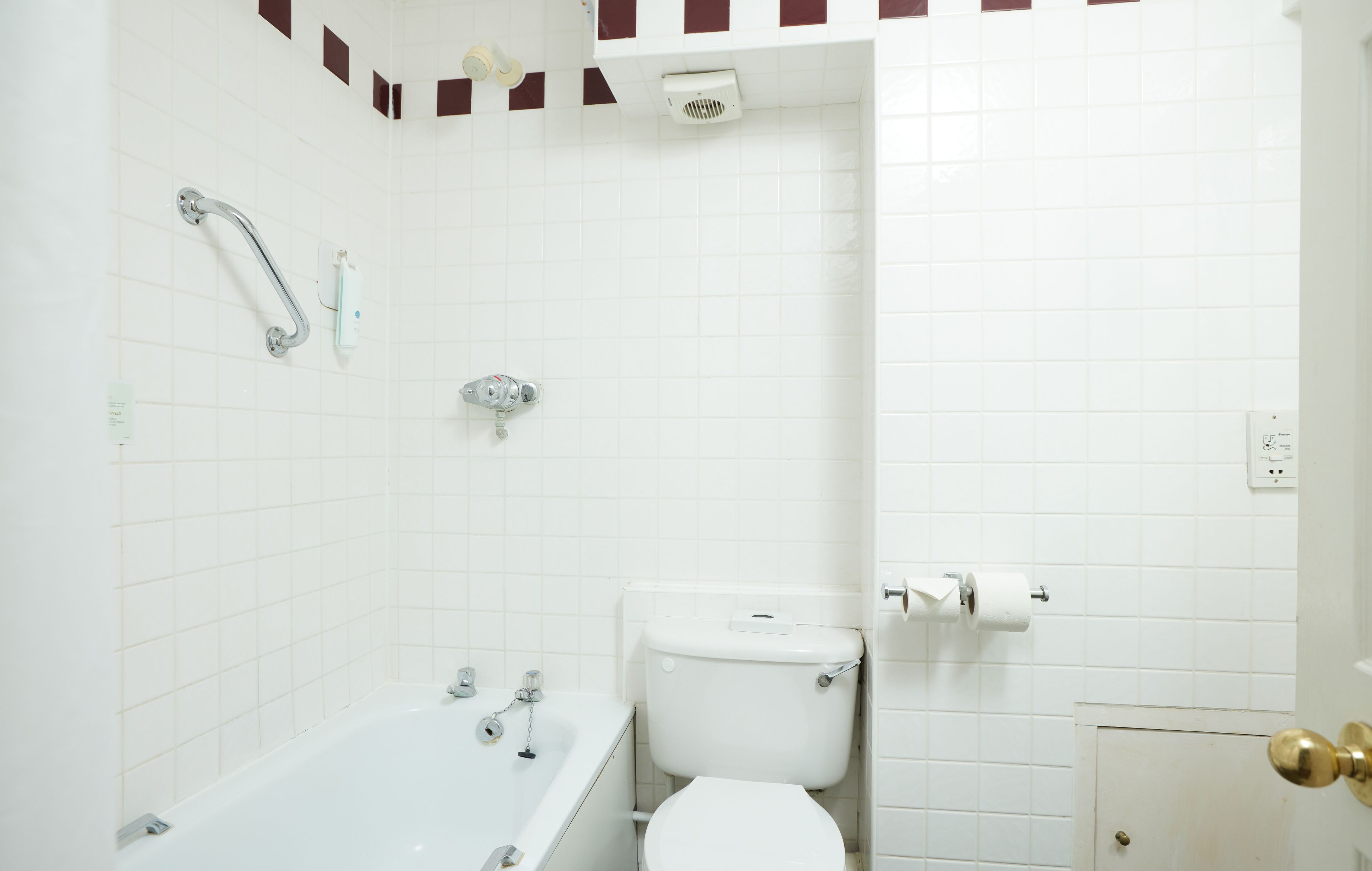 A bathroom with a bathtub, toilet, and shower.