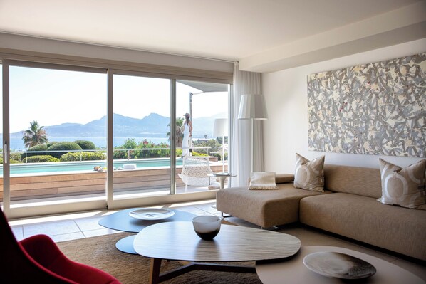 Apartment, 2 Bedrooms, Private Pool, Sea View | Living area | 100-cm flat-screen TV with satellite channels, iPod dock, books