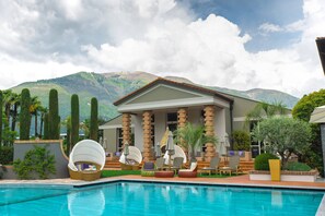 Indoor pool, seasonal outdoor pool, pool umbrellas, pool loungers