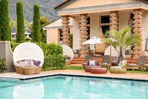 Indoor pool, seasonal outdoor pool, pool umbrellas, pool loungers