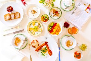 A breakfast setting with various dishes, including toast, eggs, and fruit.