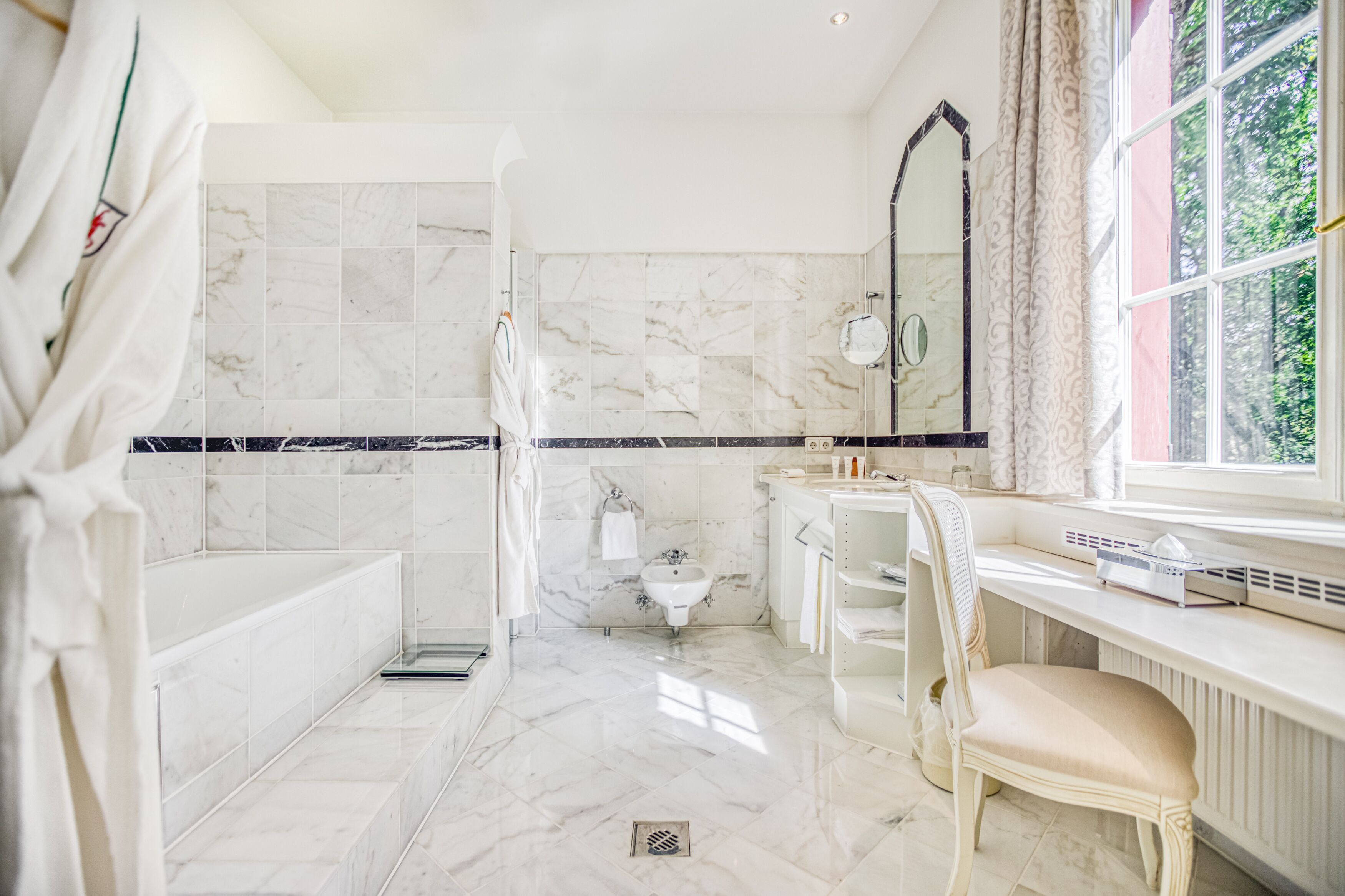 A bathroom with a shower, toilet, and sink.