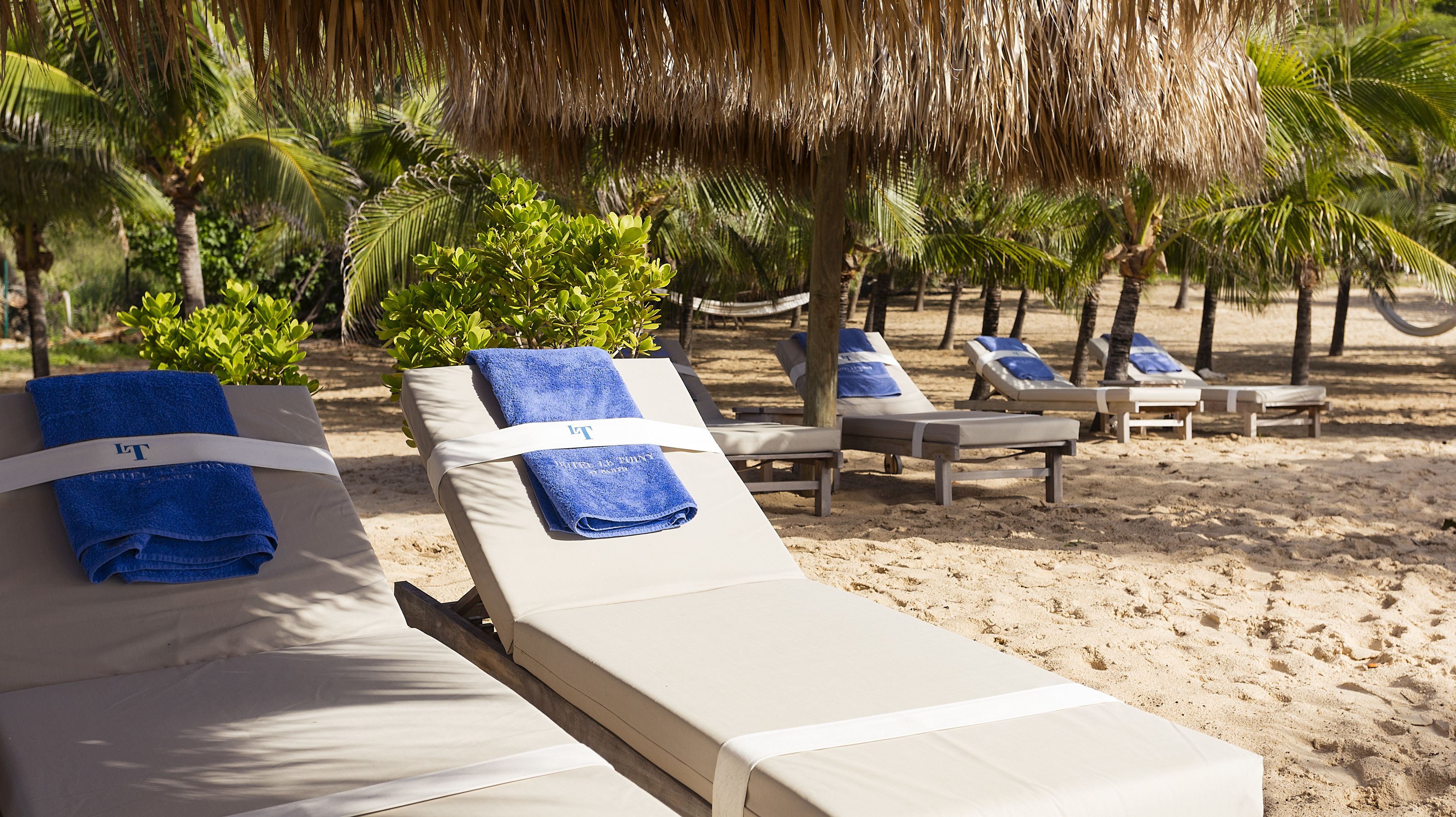 on the beach, white sand, sun-loungers, beach towels