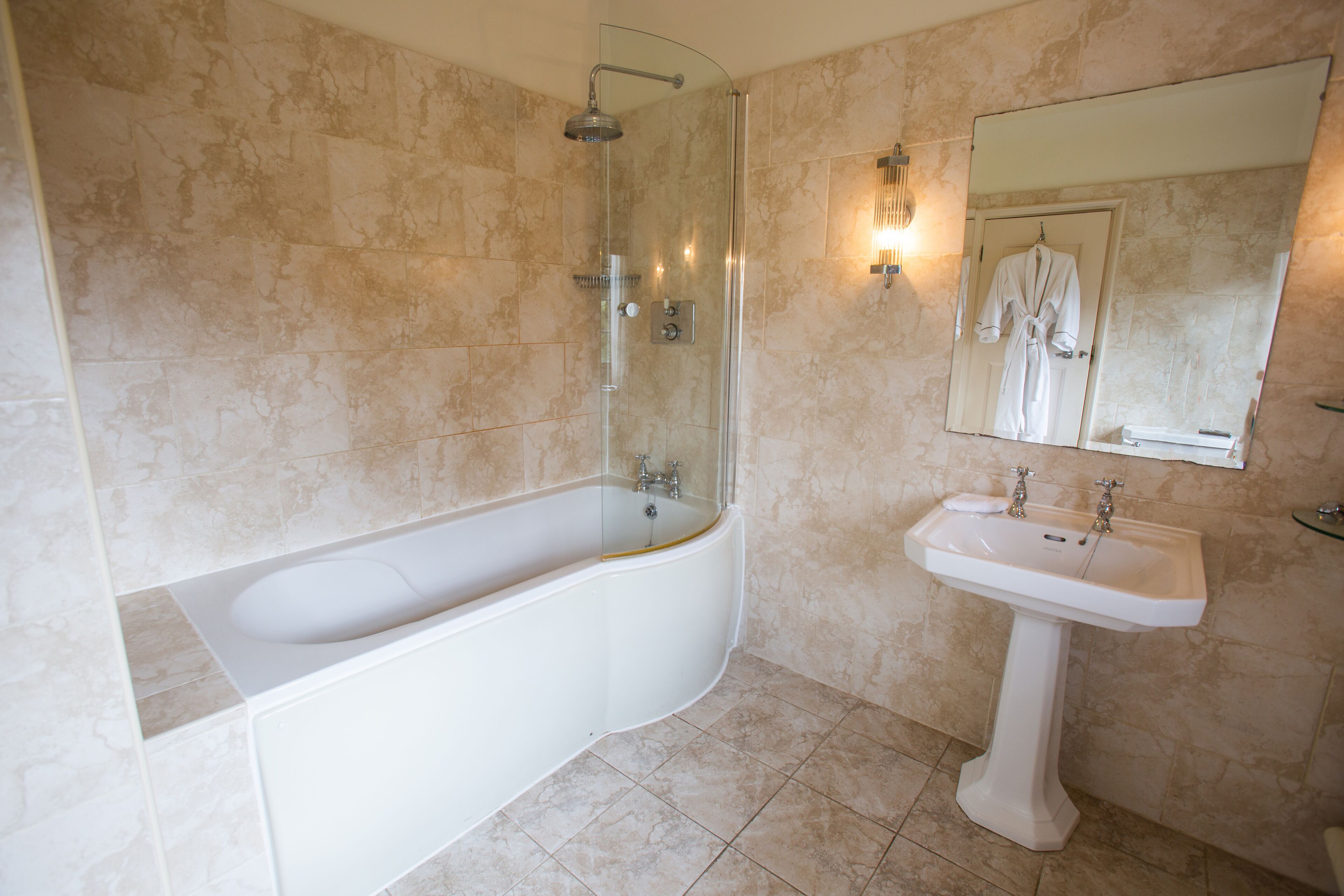 A bathroom with a bathtub, a sink, and a shower.
