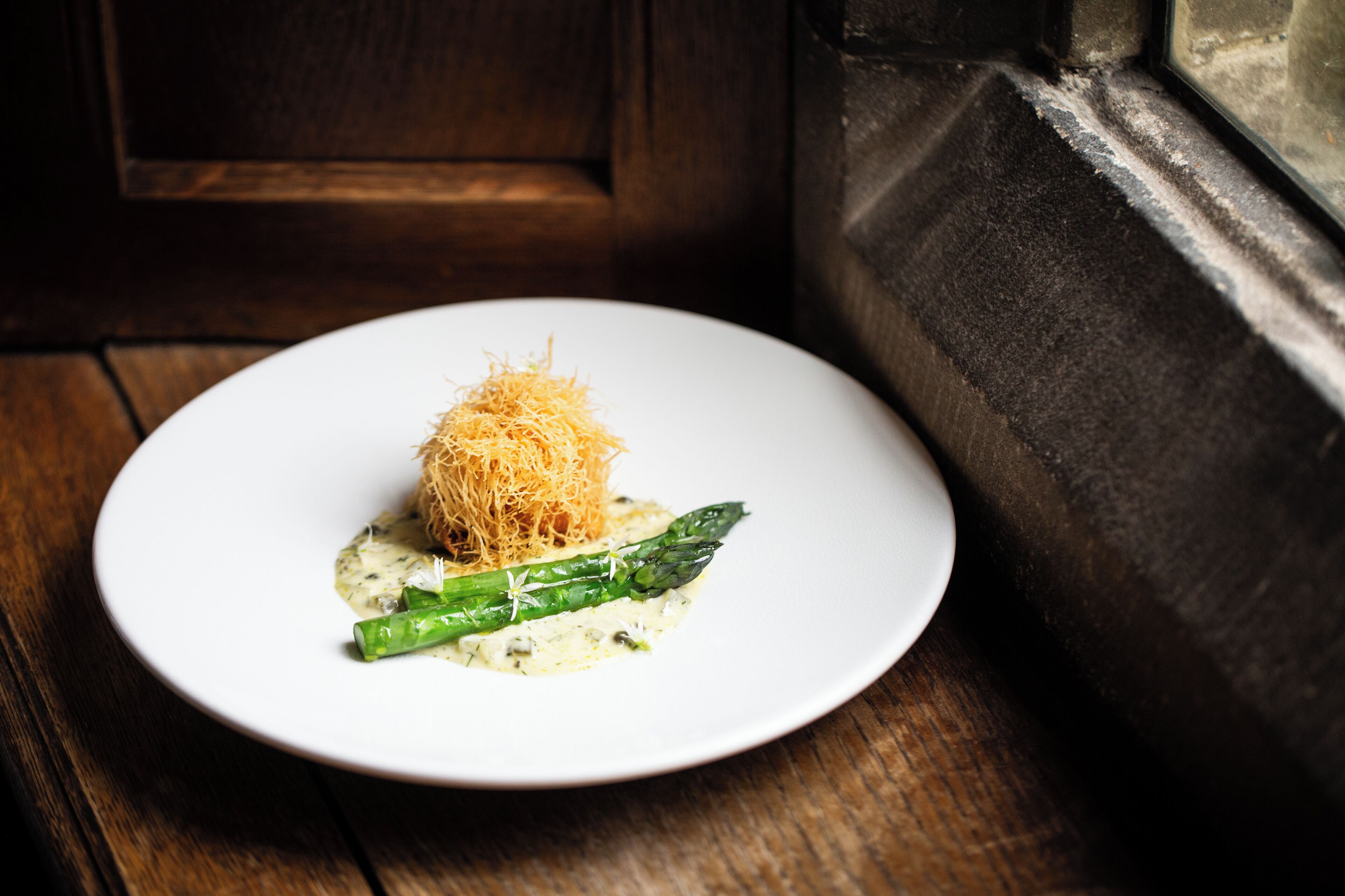 A plate of food on a wooden table.