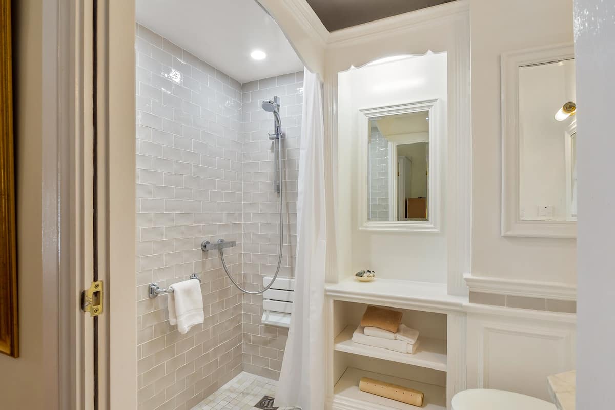 junior suite, 1 king bed, garden view, ground floor | bathroom | designer toiletries, hair dryer, towels, soap