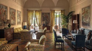 A spacious room with a large window, a fireplace, and a dining area.