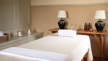 Relax in a serene space with a comfortable bed, bedside lamps, and a wicker basket.