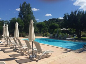 Outdoor pool, open 9:00 AM to 7:00 PM, pool umbrellas, pool loungers