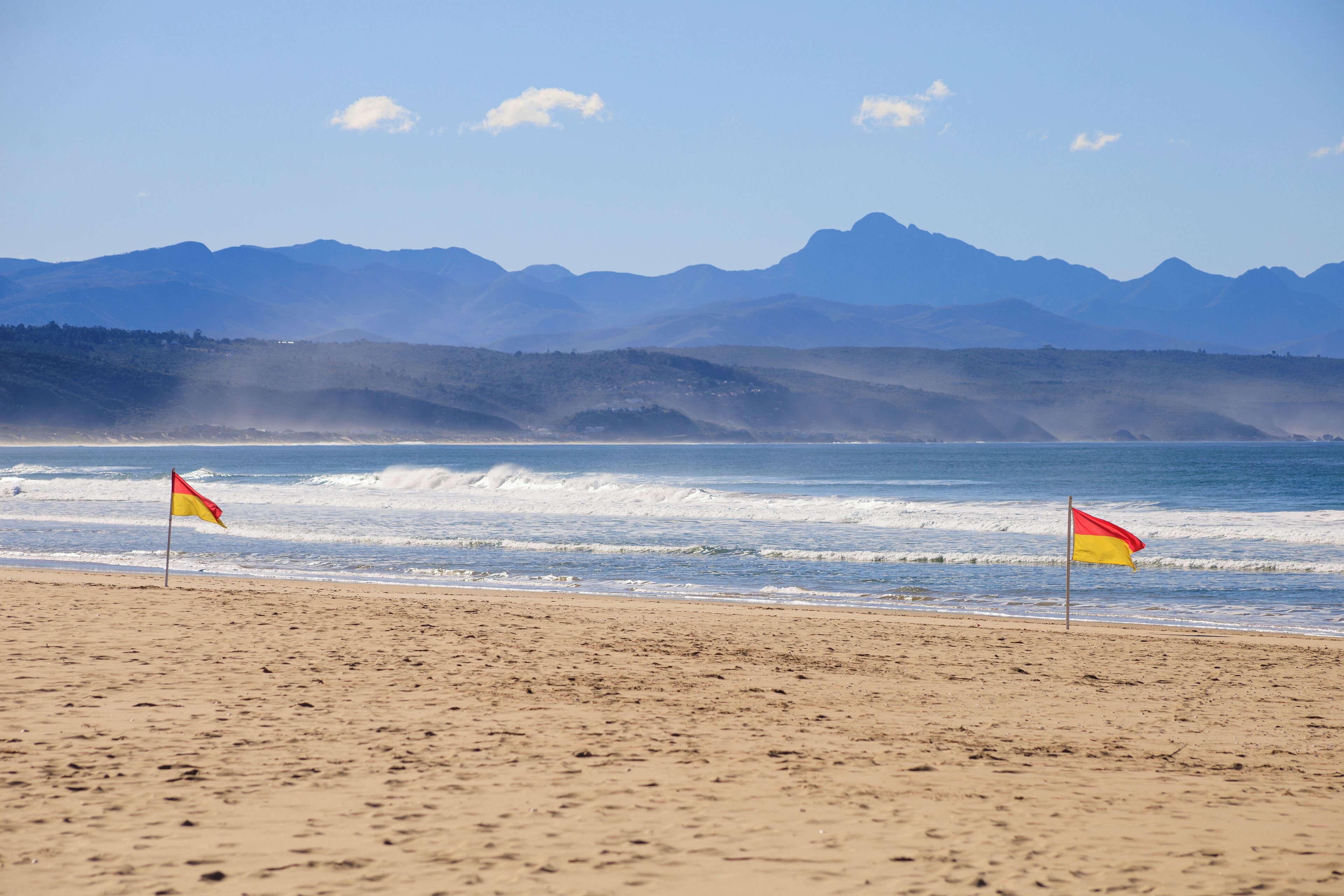 white sand, beach umbrellas, beach towels, surfing