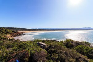 Beach nearby, white sand, beach umbrellas, beach towels