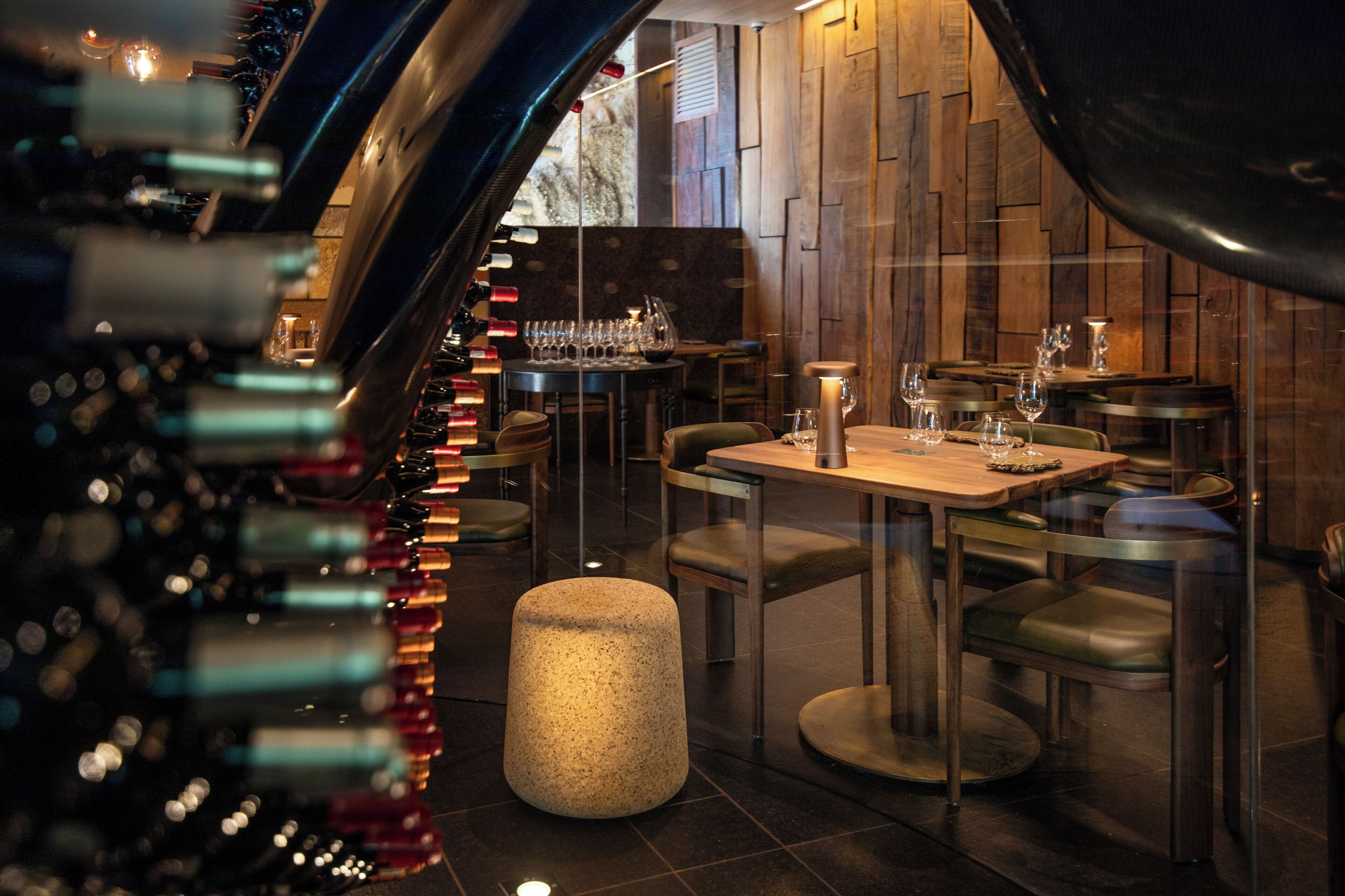 A restaurant interior with tables, chairs, and a bar area.