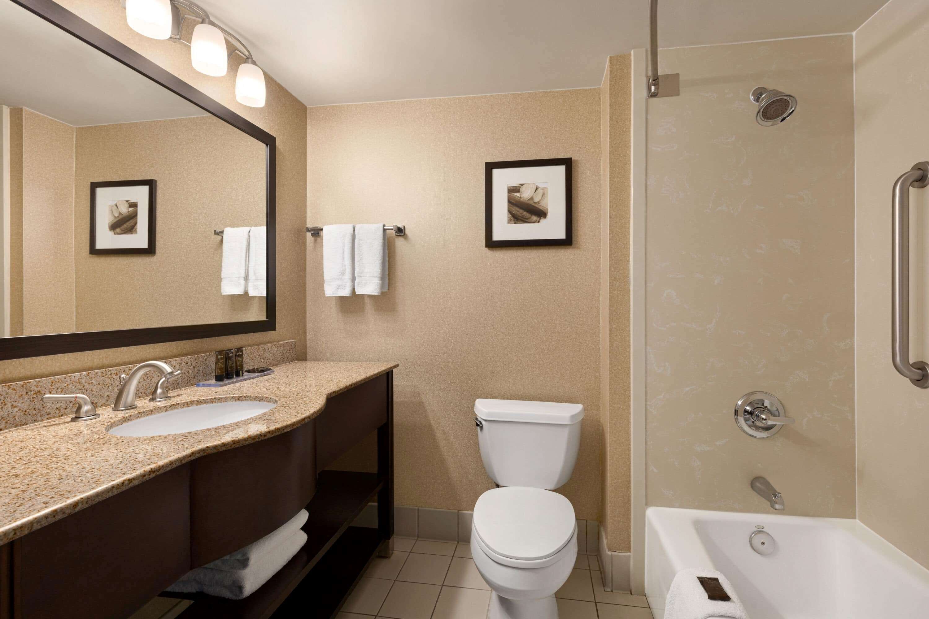 A bathroom with a sink, toilet, and bathtub.