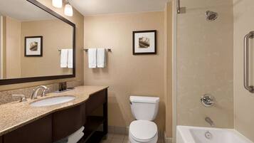 A bathroom with a sink, toilet, and bathtub.