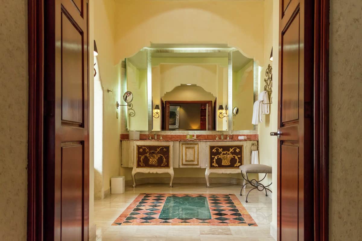 Presidential Suite, 2 Bedrooms, 2 King Beds | Living area | 55-inch TV with cable channels, iPod dock
