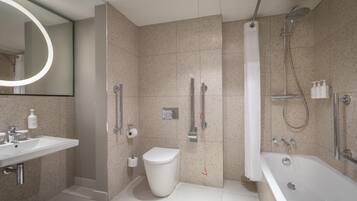 A modern bathroom with a sink, toilet, shower, and bathtub.