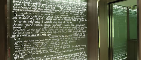 A wall with handwritten text in a hallway.