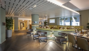 A modern restaurant interior with a bar area, seating, and a view of the outside.