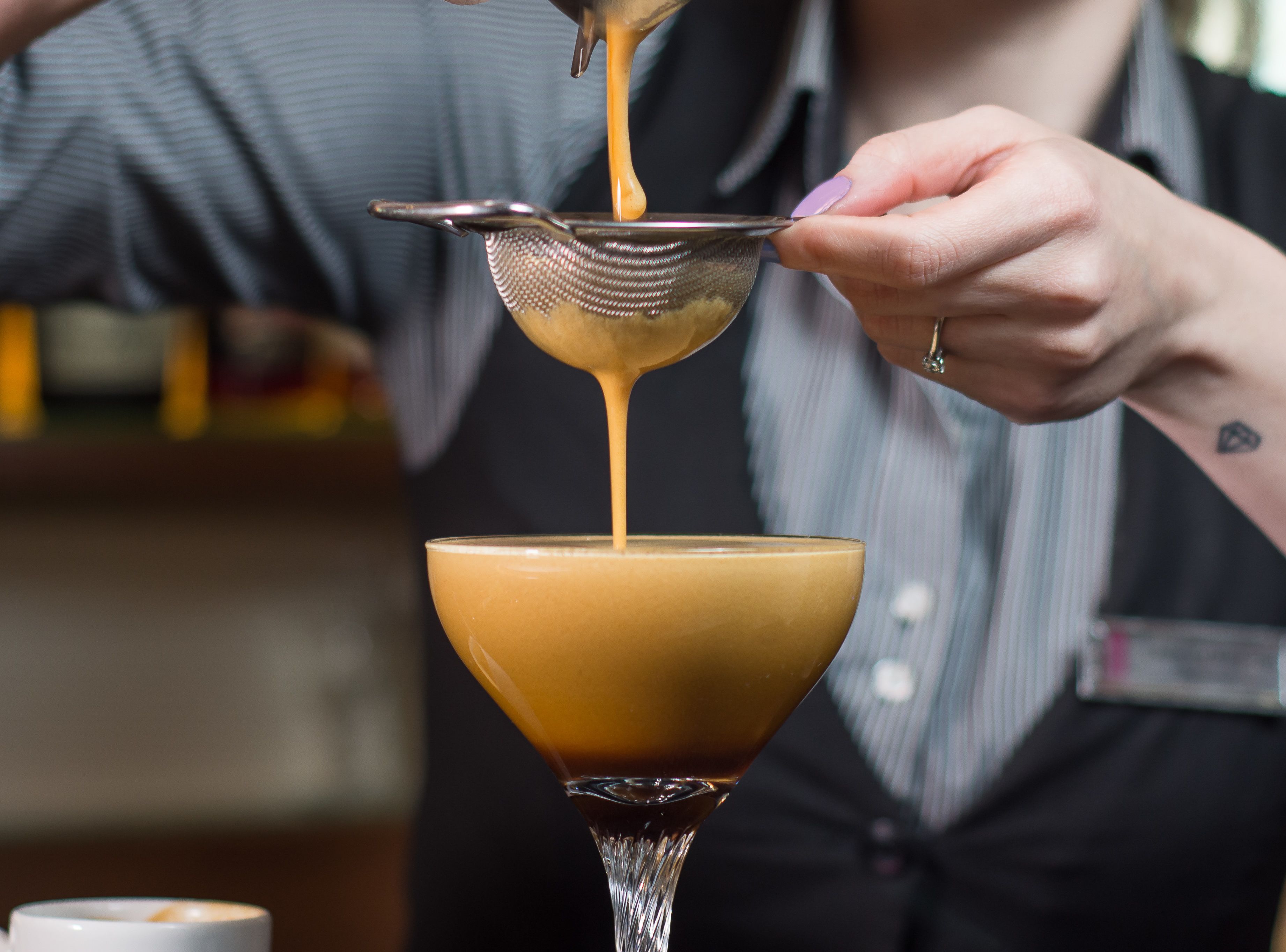 A person pouring a liquid into a glass.