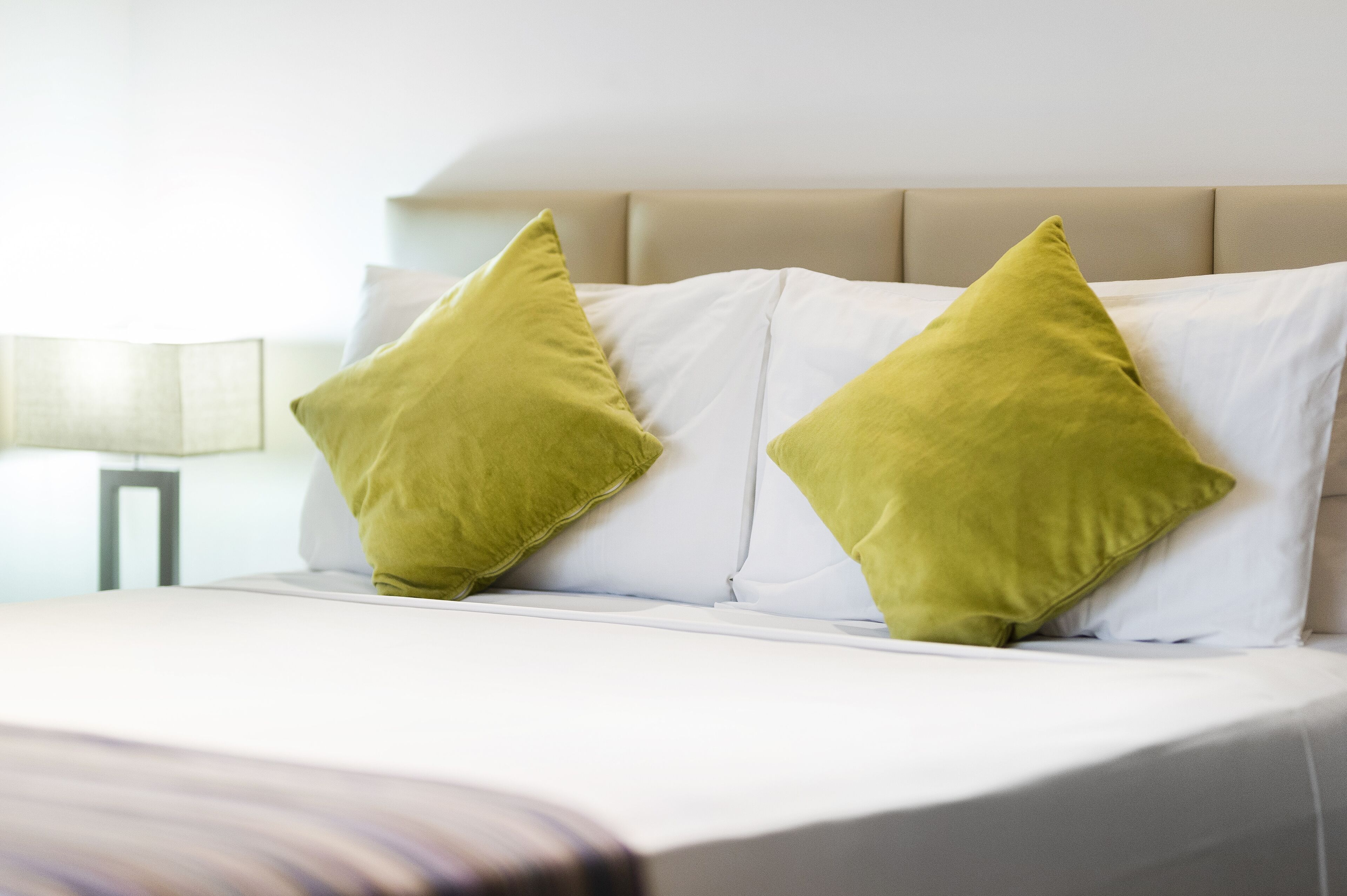 A bed with two pillows and a headboard.