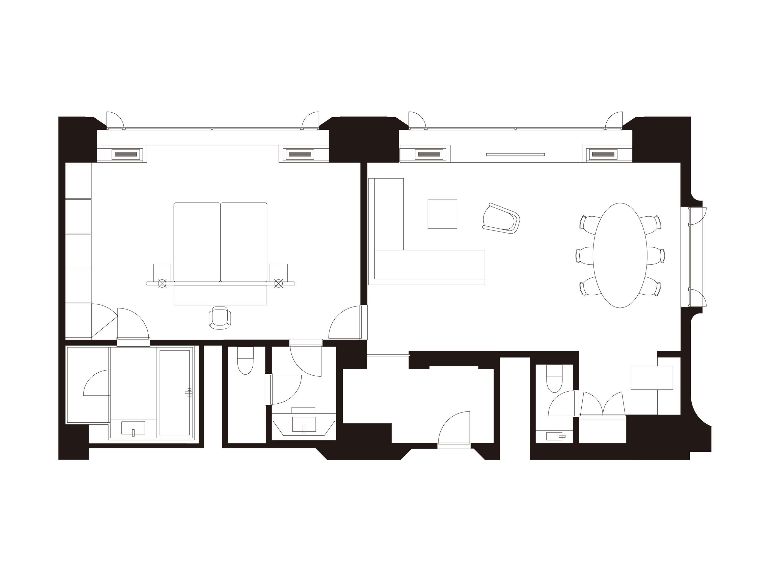 A floor plan of a hotel room with a bed, a desk, a chair, a bathroom, and a small sitting area.