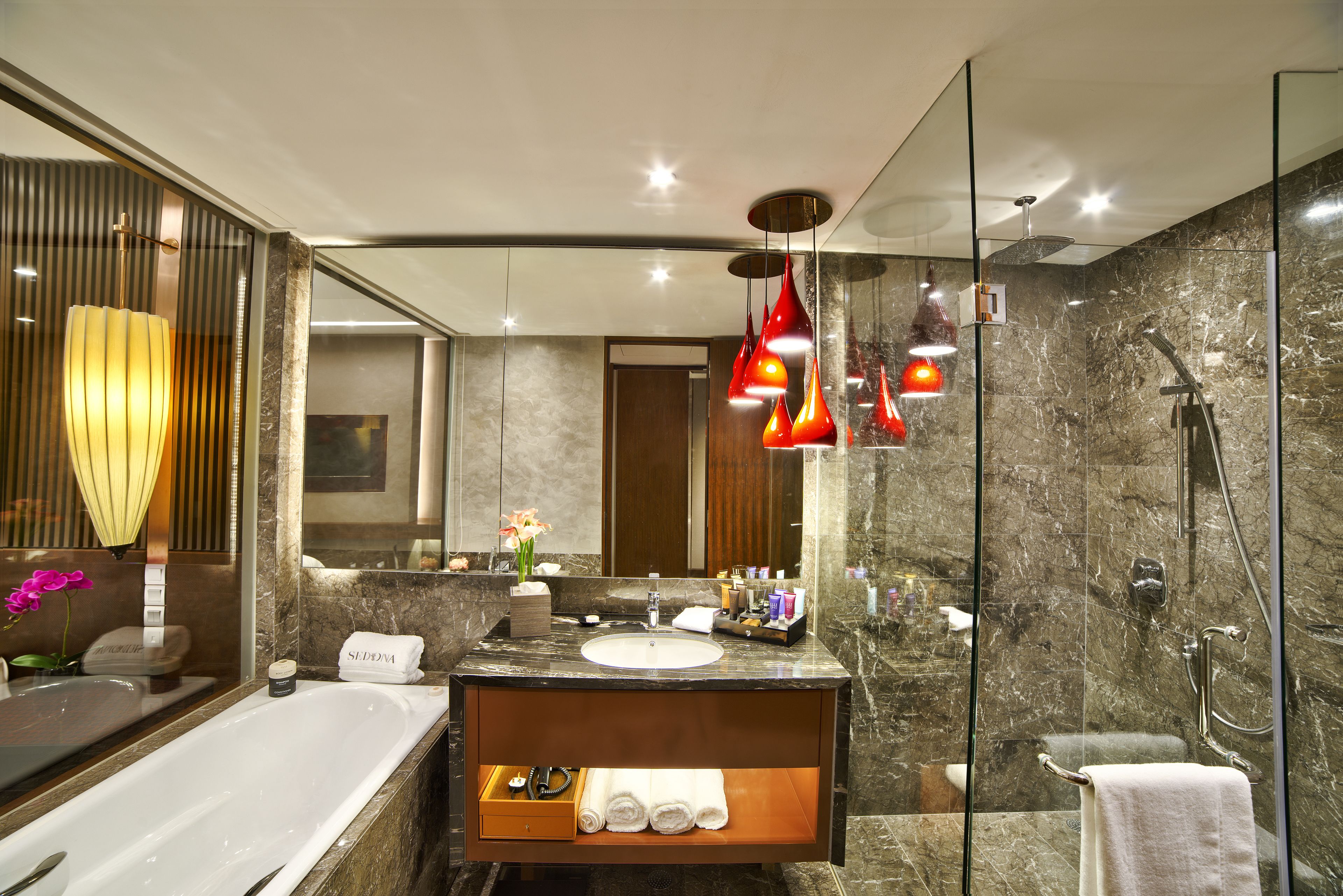 deep-soaking bathtub, designer toiletries, hair dryer, bathrobes