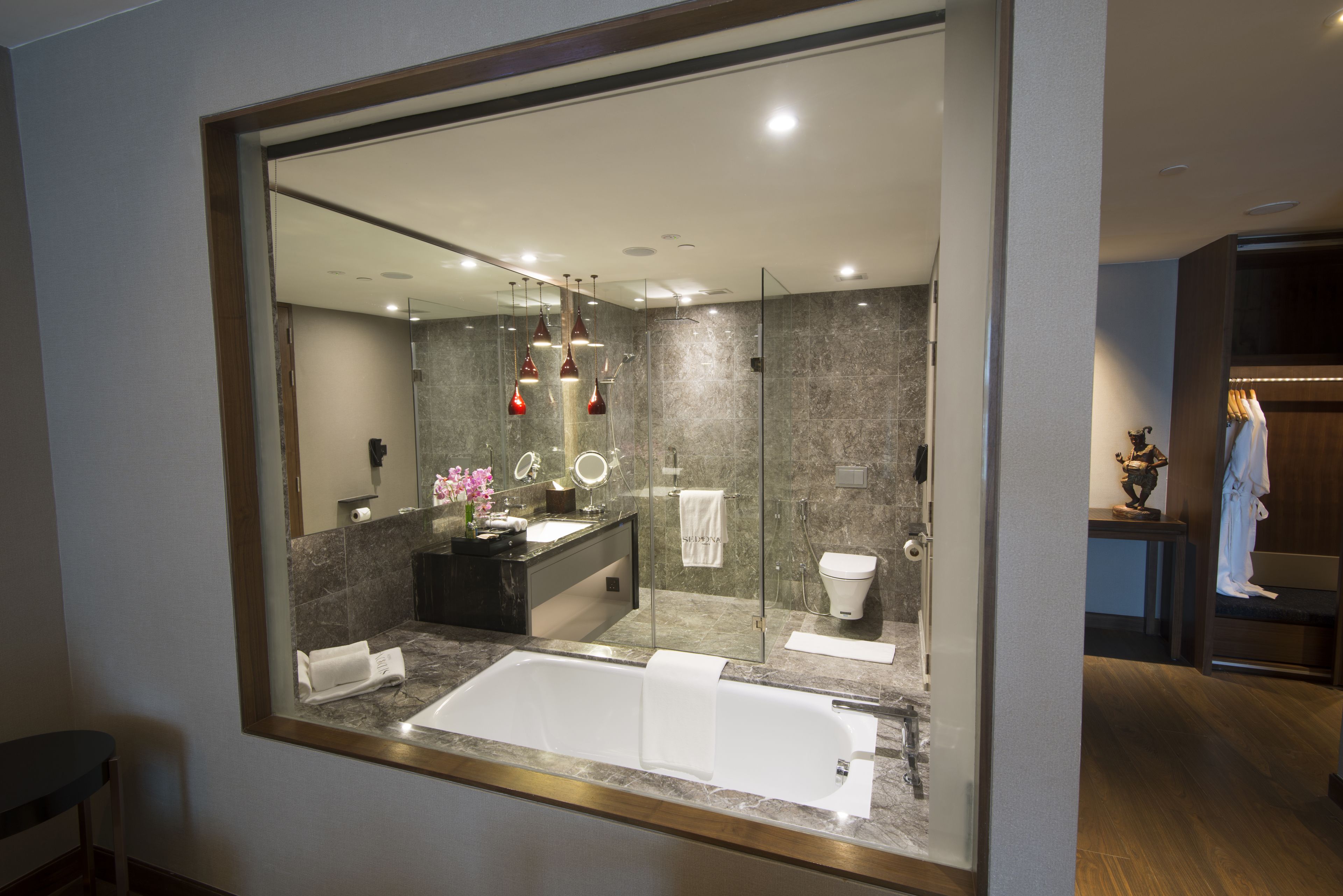 deep-soaking bathtub, designer toiletries, hair dryer, bathrobes