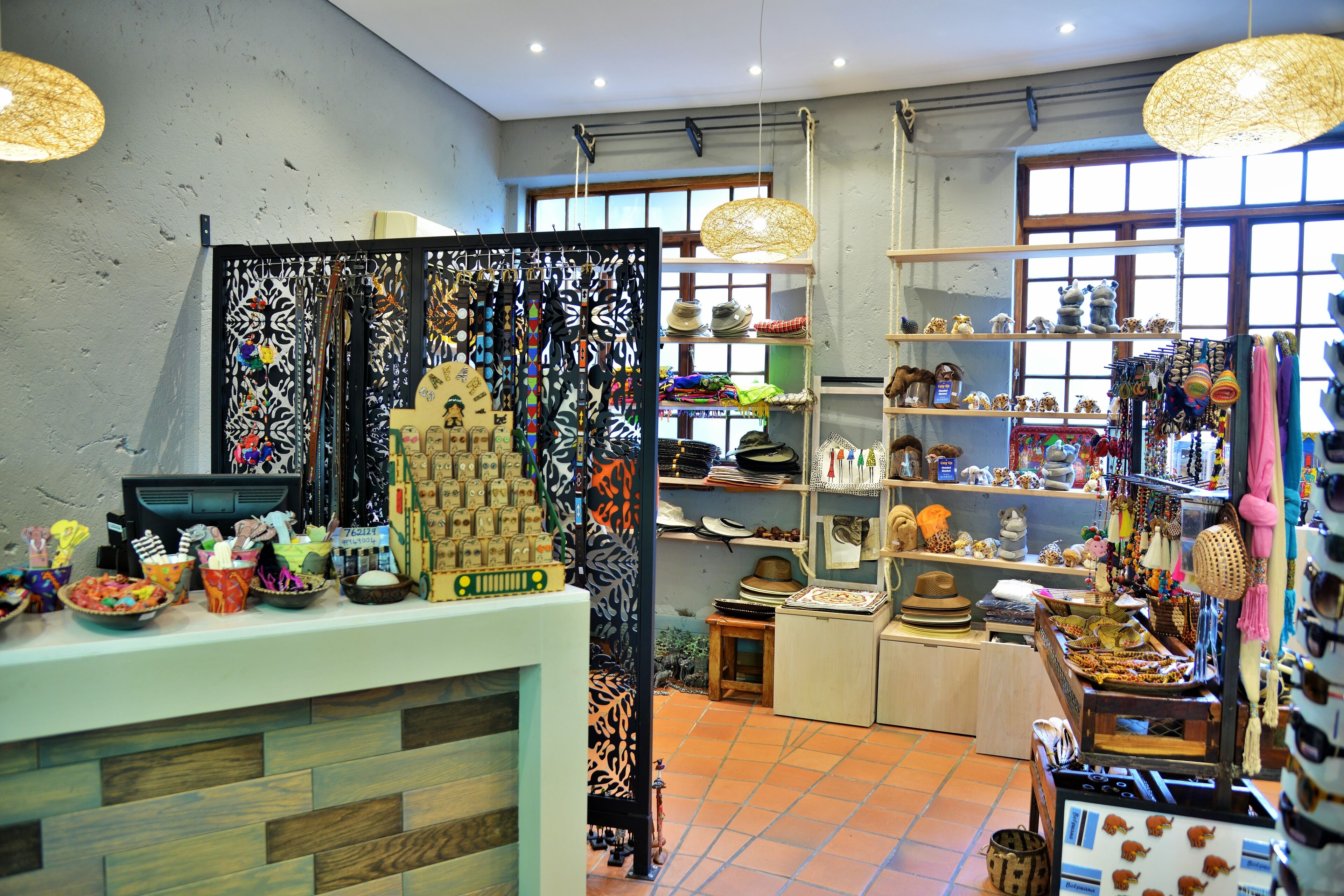 A boutique store with various items on display, including hats, scarves, and decorative objects.