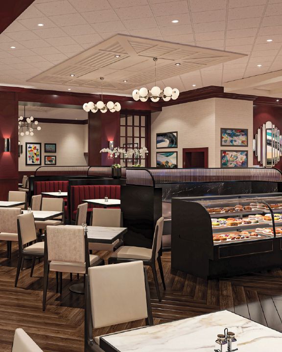 A restaurant with booths, tables, and a dessert display.