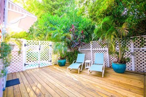 A wooden deck with three lounge chairs and potted plants. - Ambrosia Key West (Key West)
