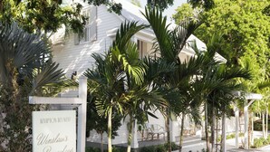 A white building with a sign reading 'Kimpton Key West Winslow's Bungalow.' - Winslow's Bungalows - Key West Historic Inns (Key West)