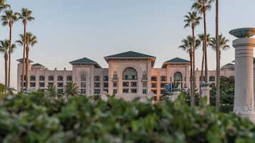 A large, multi-story hotel with a symmetrical facade, featuring arched windows and a central entrance.