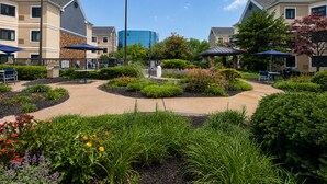 A landscaped courtyard with outdoor seating, a gazebo, and a central fountain. - Staybridge Suites Columbia Baltimore by IHG (Columbia)