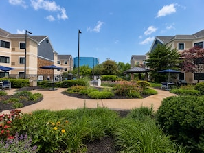 A landscaped courtyard with outdoor seating, a gazebo, and a central fountain. - Staybridge Suites Columbia Baltimore by IHG (Columbia)