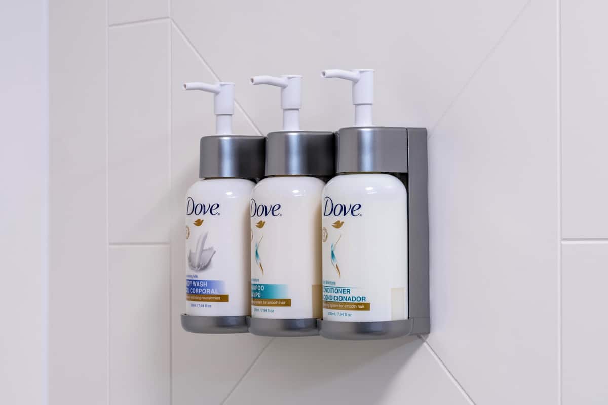 Three Dove personal care products mounted on a wall.