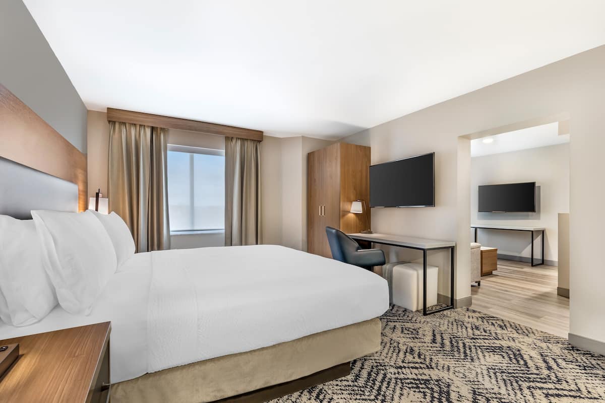 Premium bedding, desk, laptop workspace, blackout drapes
