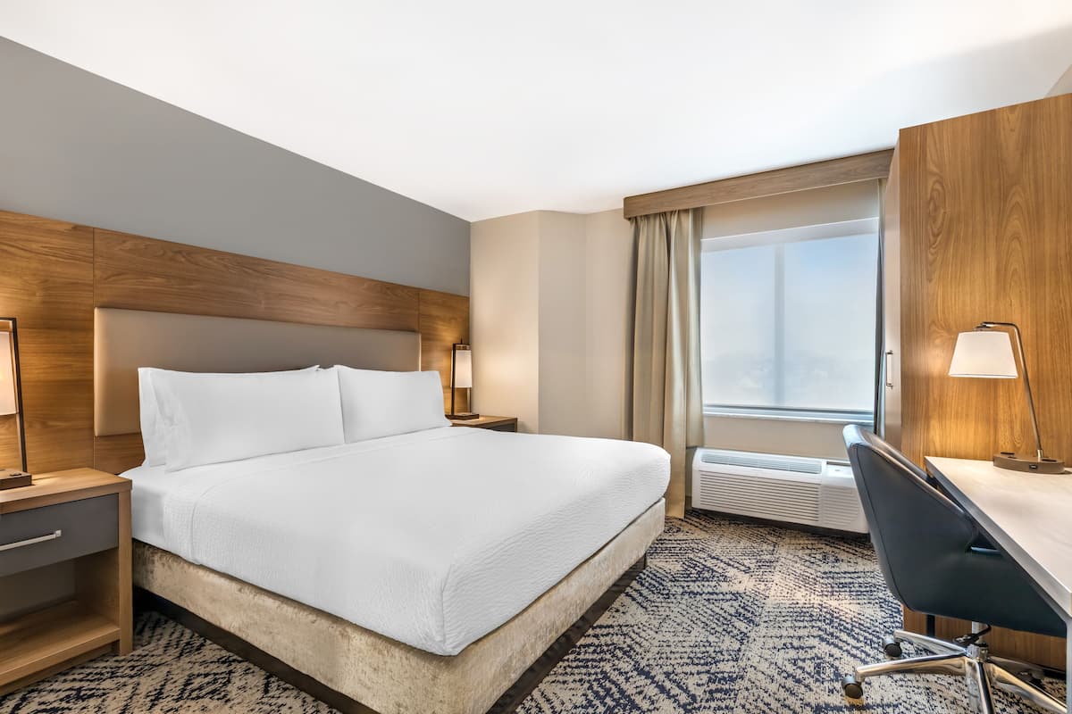 Premium bedding, desk, laptop workspace, blackout drapes