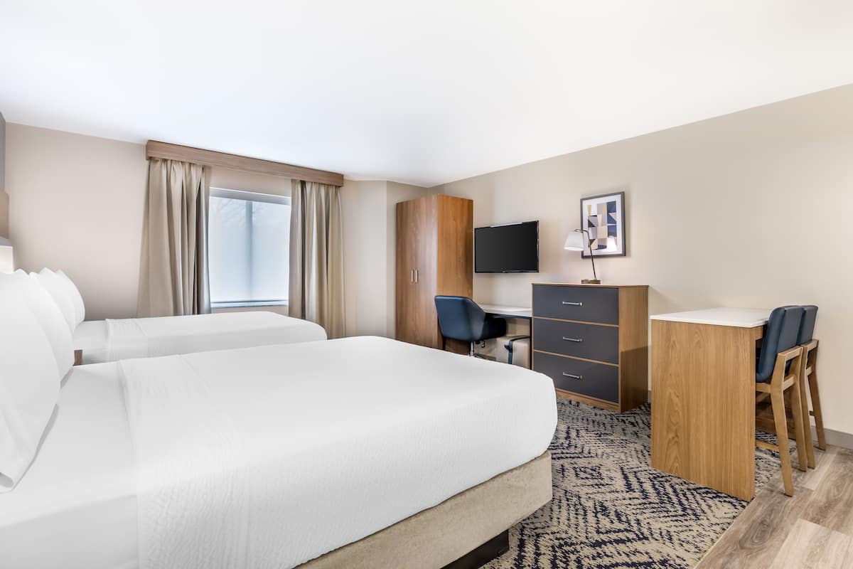 Premium bedding, desk, laptop workspace, blackout drapes